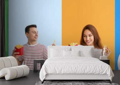 Set of happy young people with different fast food on colorful background Wall mural