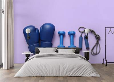 Set of sports equipment on lilac background, top view Wall mural