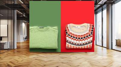 Set of warm knitted sweaters on colorful background, top view Wall mural