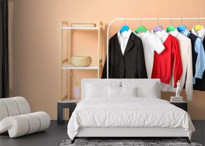 Shelf unit and rack with school uniform near color wall Wall mural