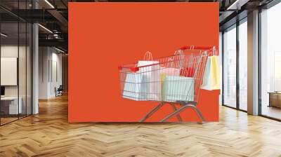 Shopping bags in cart on orange background Wall mural