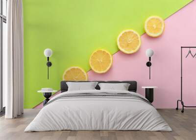 Slices of ripe lemon on color background Wall mural