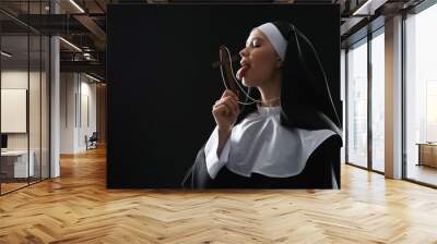 Slutty nun with cross on dark background Wall mural