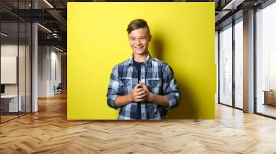 Smiling teenage boy on color background Wall mural