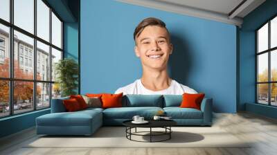 Smiling teenage boy on color background Wall mural