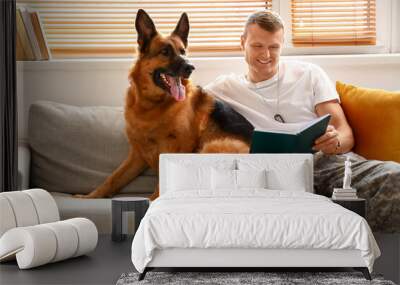 Soldier of USA army with military working dog reading book at home Wall mural