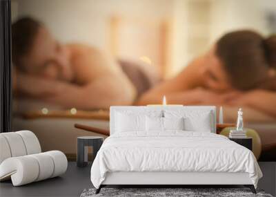 Spa composition with candles and relaxing couple on background Wall mural