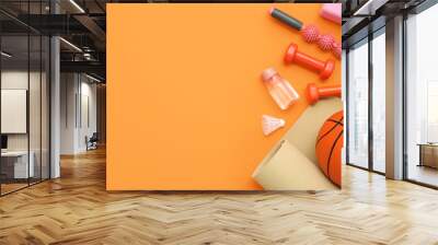 Sport equipment with basketball and dumbbells on orange background. Top view Wall mural