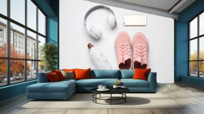 Sportive shoes, bottle of water, mobile phone and headphones on white background Wall mural