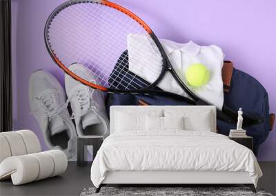 Sports bag with ball, tennis rackets and shoes on purple background Wall mural