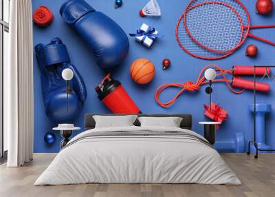 Sports equipment with Christmas balls and gifts on blue background Wall mural