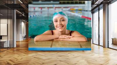 Sporty female swimmer in pool Wall mural