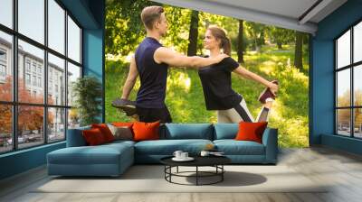 Sporty young couple training outdoors Wall mural