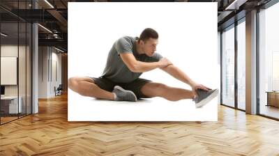 Sporty young man training against white background Wall mural