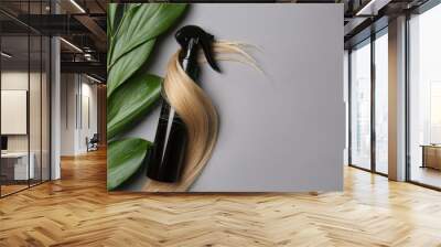 Spray bottle with cosmetic for hair on grey background, top view Wall mural