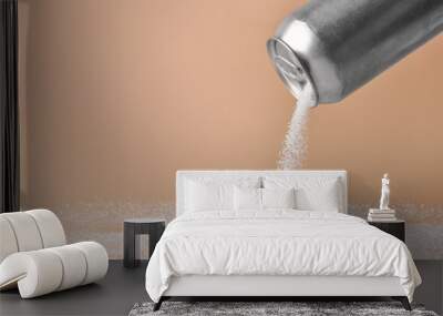 Sprinkling of sugar from tin can onto color background Wall mural