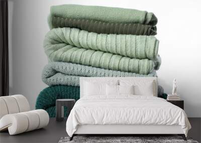 Stack of knitted sweaters on white background Wall mural