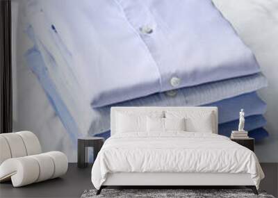 Stack of stylish male shirts on fabric background Wall mural