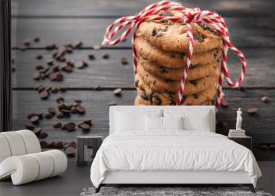 Stack of tasty cookies with chocolate chips on dark wooden table Wall mural