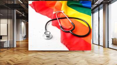 Stethoscope and rainbow LGBT flag on light  background Wall mural