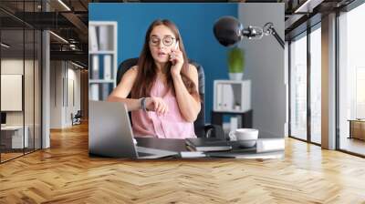 Stressed businesswoman trying to meet deadline in office Wall mural