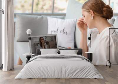 Stressed young woman asking psychologist for advice online at home Wall mural