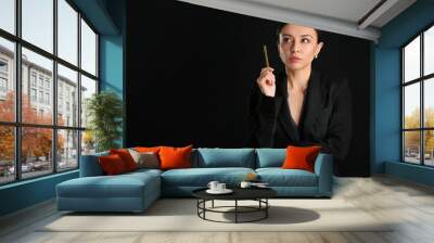 Stylish businesswoman on dark background Wall mural