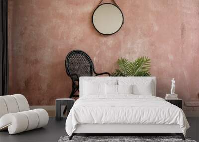 Stylish chair, houseplant and mirror hanging on pink wall Wall mural