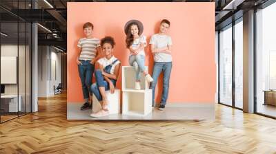 Stylish children in jeans near color wall Wall mural