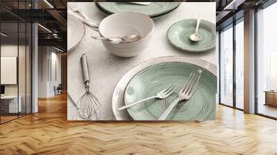 Stylish dinnerware and kitchen utensils on light table, closeup Wall mural