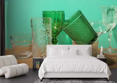 Stylish empty glasses on color background Wall mural