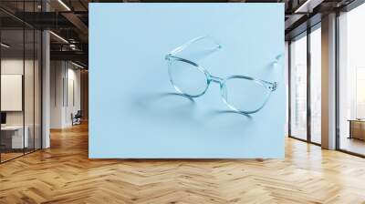 Stylish eyeglasses on color background Wall mural