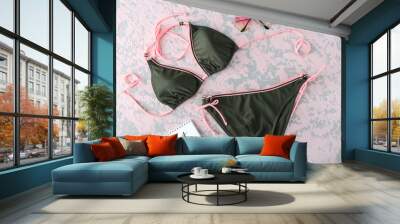 Stylish female swimming suit, calendar and sunglasses on color background Wall mural