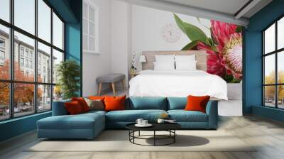 Stylish interior of bedroom with beautiful exotic flowers on wall Wall mural