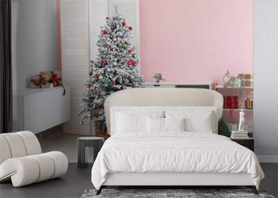 Stylish interior of living room with decorated Christmas tree and gifts Wall mural