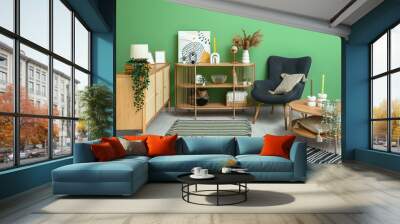 Stylish interior of living room with drawers, shelving unit, armchair and soft rugs Wall mural