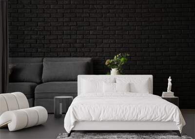 Stylish interior of room with comfortable big sofa near dark brick wall Wall mural