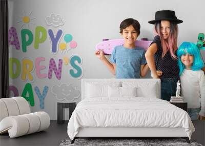 Stylish little children with skateboards on light background Wall mural