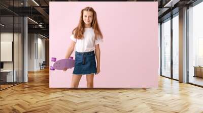 Stylish little girl with skateboard on color background Wall mural