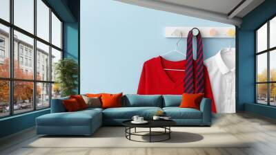 Stylish school uniform hanging on color wall Wall mural