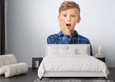 Surprised little boy on white background Wall mural