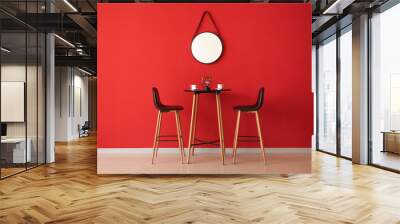 Table and chairs near color wall with mirror Wall mural