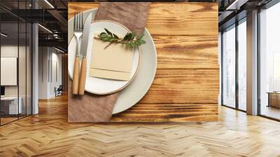 Table setting with floral decor and blank card on wooden background Wall mural