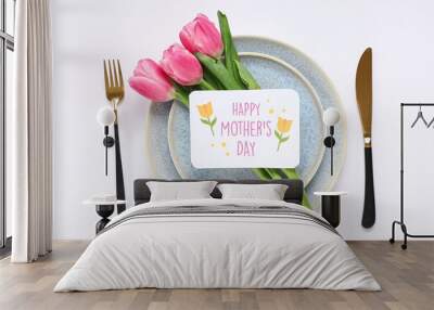 Table setting with greeting card for Mother's day and tulips isolated on white background Wall mural