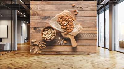 Tasty almonds on wooden background Wall mural