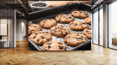 Tasty cookies with chocolate chips on baking tray Wall mural