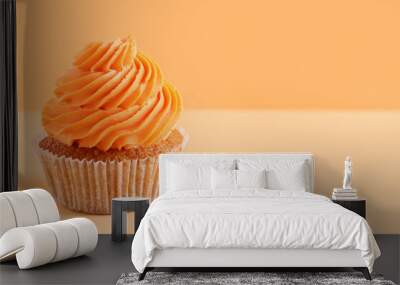 Tasty cupcake on orange background Wall mural