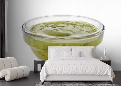 Tasty green sauce in bowl on white background Wall mural