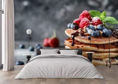 Tasty homemade pancakes with berries on wooden board, closeup Wall mural