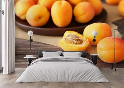 Tasty ripe apricots on wooden table, closeup Wall mural